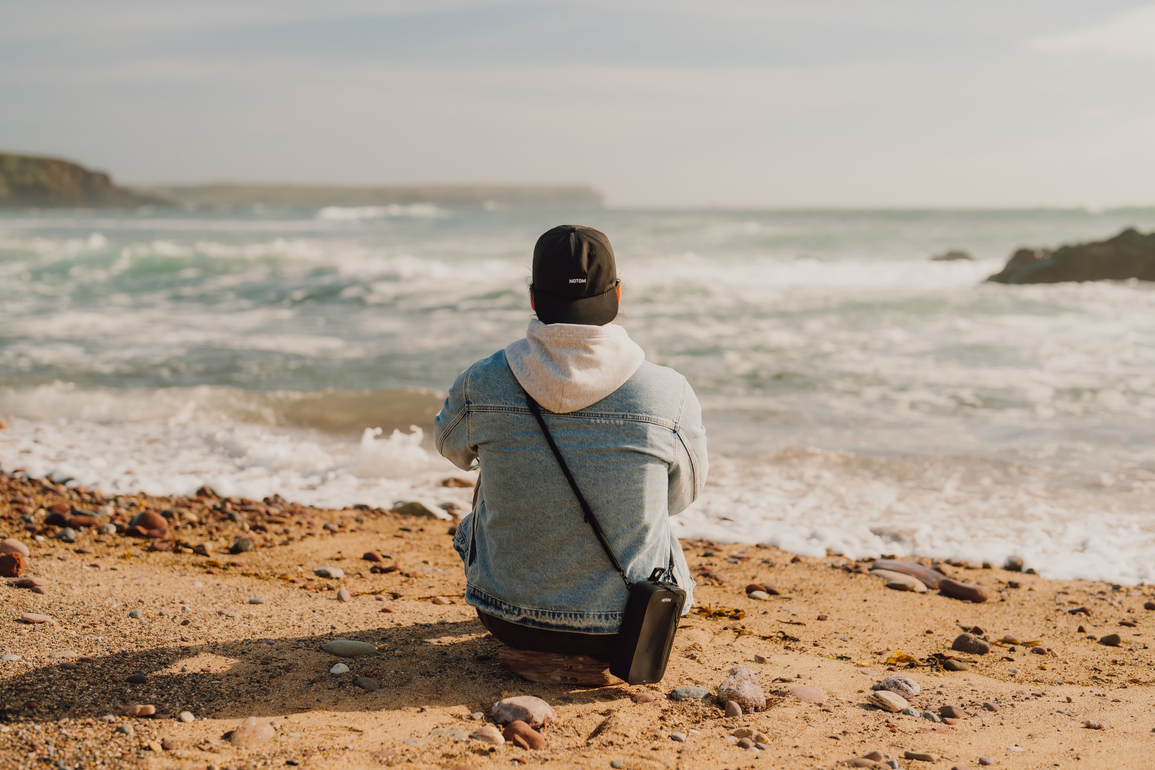 Prepared with NOTOM Sling Bag on the beach overlooking the ocean